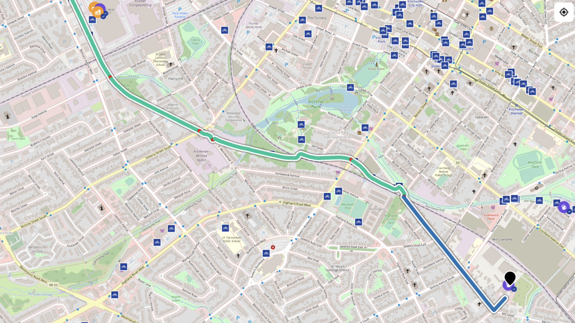 A street map shows part of Kitchener and Waterloo. There's a route trace that's mostly green and blue going from top left to bottom right. There are many small blue retables with white bike icons marked on them.